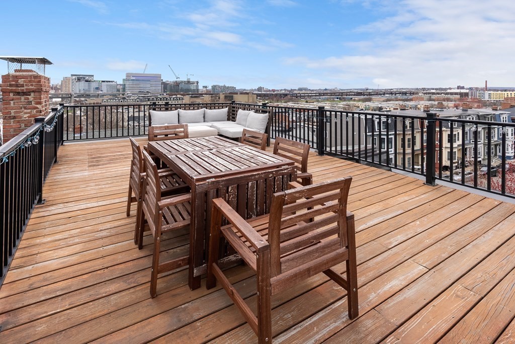 87 High Street, Unit 1 Boston, MA 02129 - Photo 13 of 18 a view of a roof deck with two chairs and wooden floor