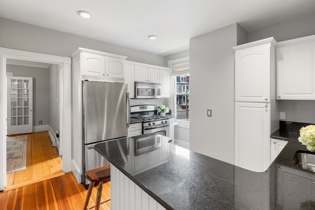 87 High Street, Unit 1 Boston, MA 02129 - Photo 4 of 18 a kitchen with stainless steel appliances granite countertop a refrigerator and a stove top oven