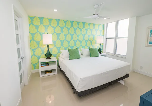 a bedroom with a bed table and a window