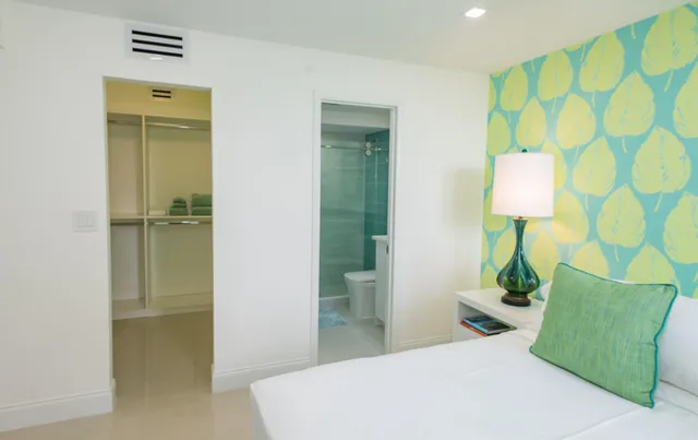 a bedroom with a bed and a lamp