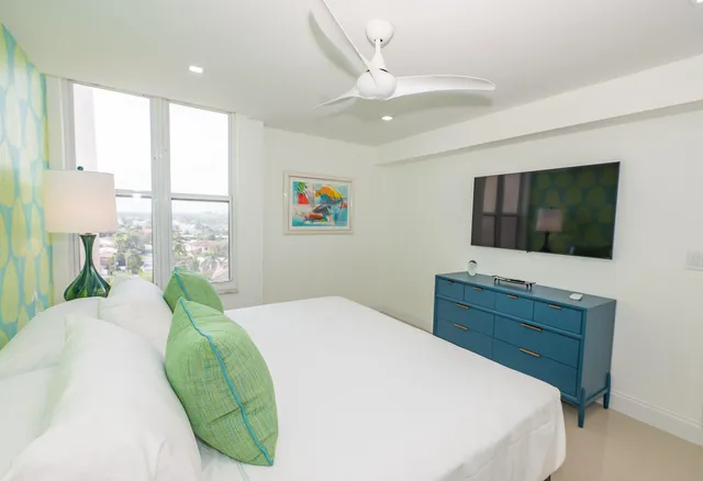 a bedroom with a bed and a flat screen tv