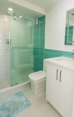 a bathroom with a toilet a sink and shower