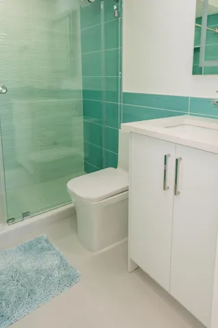 a bathroom with a toilet and a shower