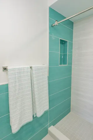a view of bathroom with shower and a bathtub