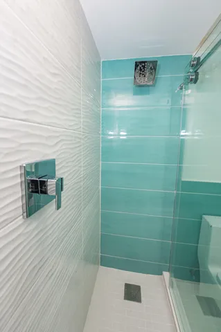 a bathroom with a shower and a sink