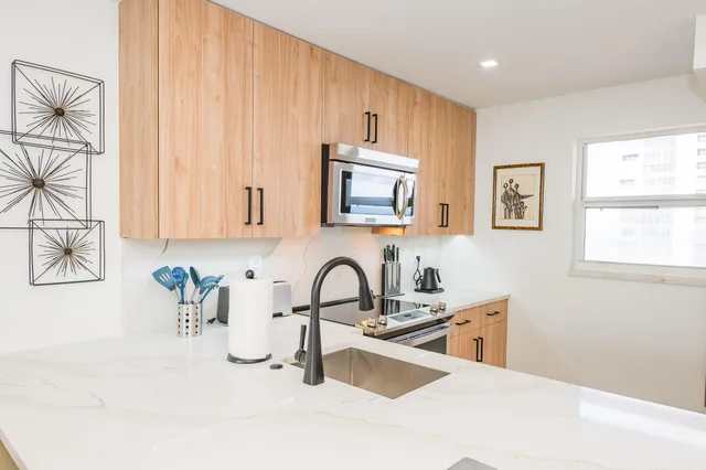 a kitchen with a sink cabinets and window
