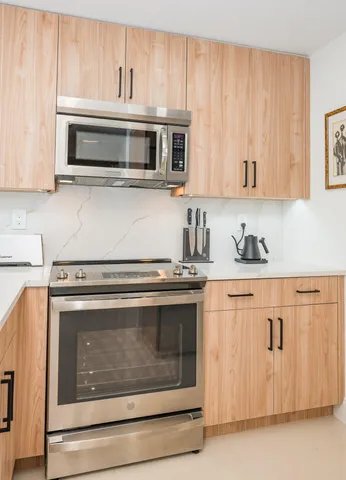 a stove top oven sitting inside of a kitchen