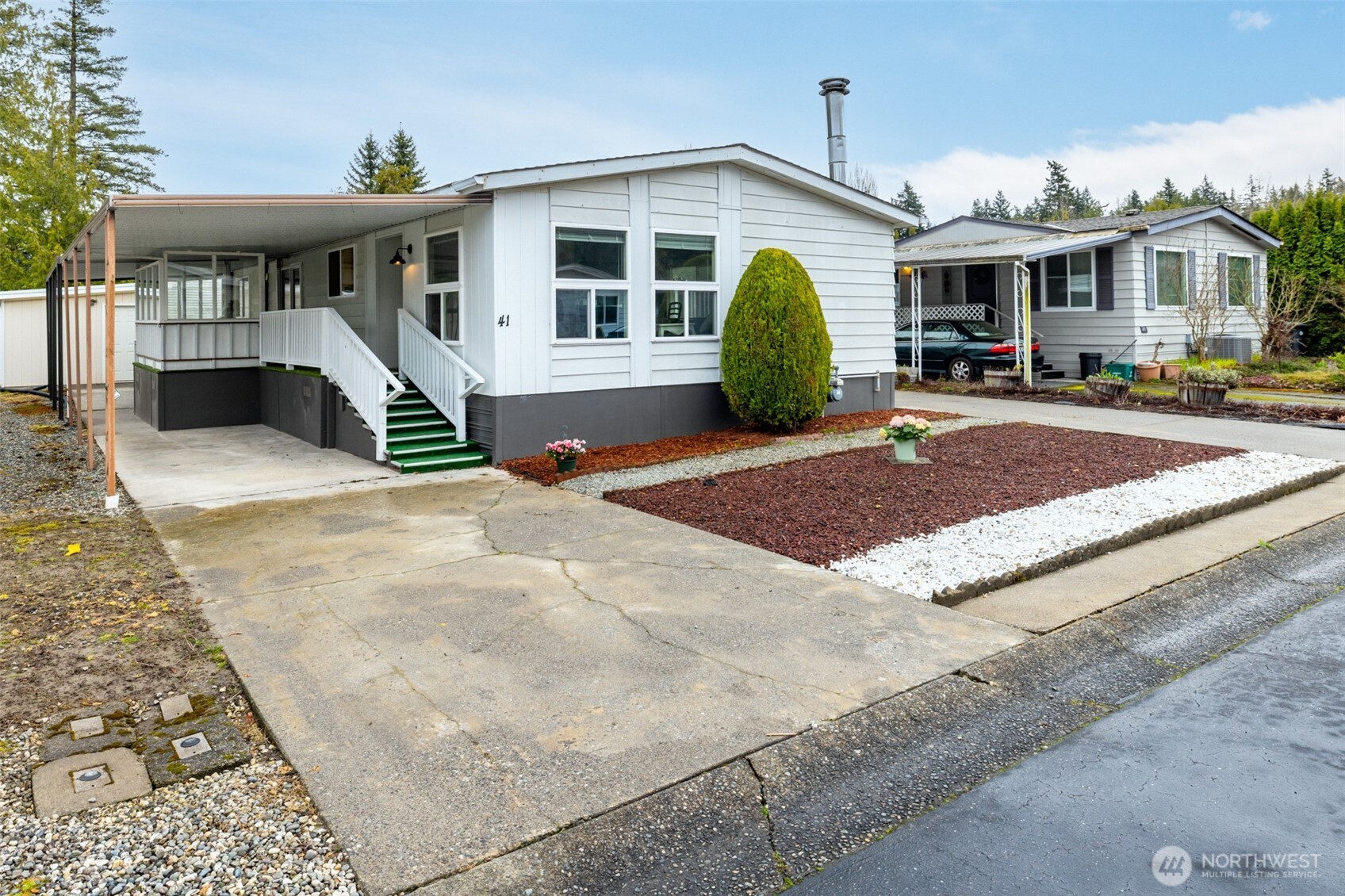 2725 East Fir Street, Unit 41 Mount Vernon, WA 98273 - Photo 1 of 38 a view of a white house with large windows and palm trees