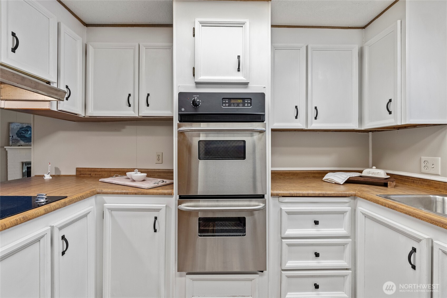 2725 East Fir Street, Unit 41 Mount Vernon, WA 98273 - Photo 13 of 38 a kitchen with white cabinets and appliances