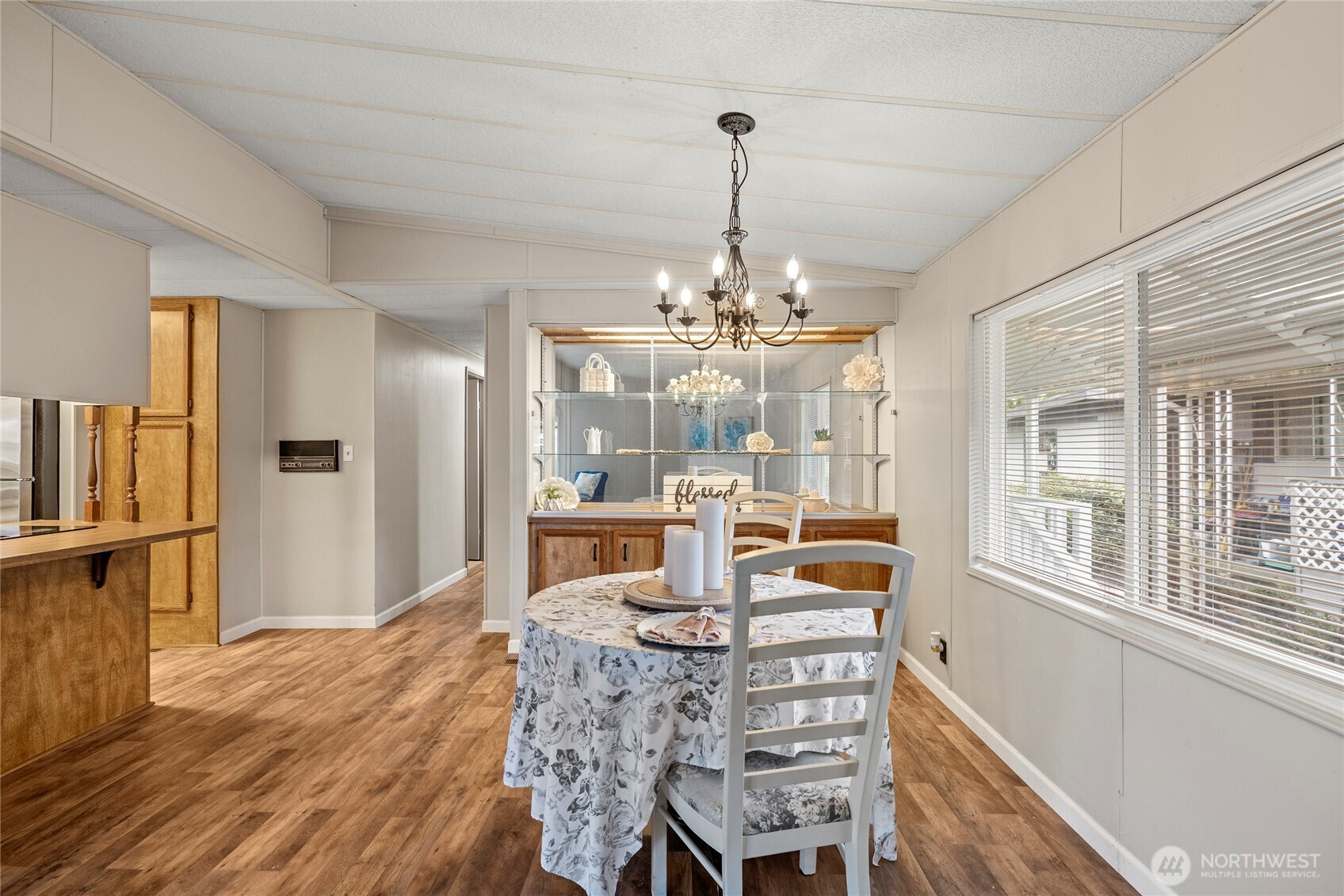 2725 East Fir Street, Unit 41 Mount Vernon, WA 98273 - Photo 9 of 38 a view of a dining room with furniture a chandelier and wooden floor