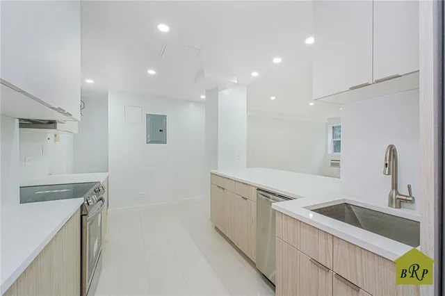 a kitchen with a sink appliances and cabinets