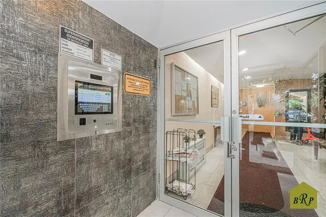 a view of a hallway with dining area and chandelier