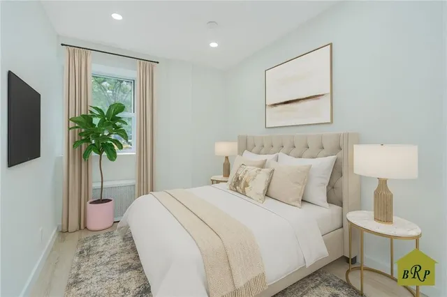 a bedroom with a bed and a potted plant