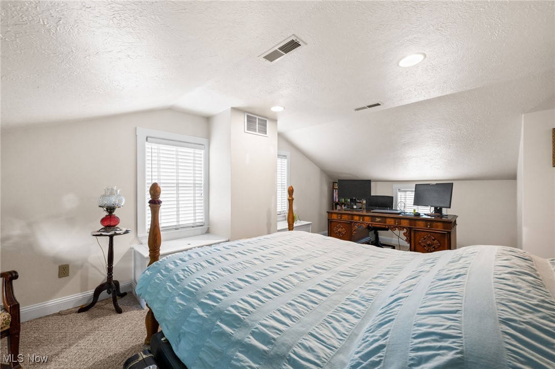 3945 Columbia Road Medina, OH 44256 - Photo 25 of 40 Bedroom with a textured ceiling, carpet flooring, and lofted ceiling