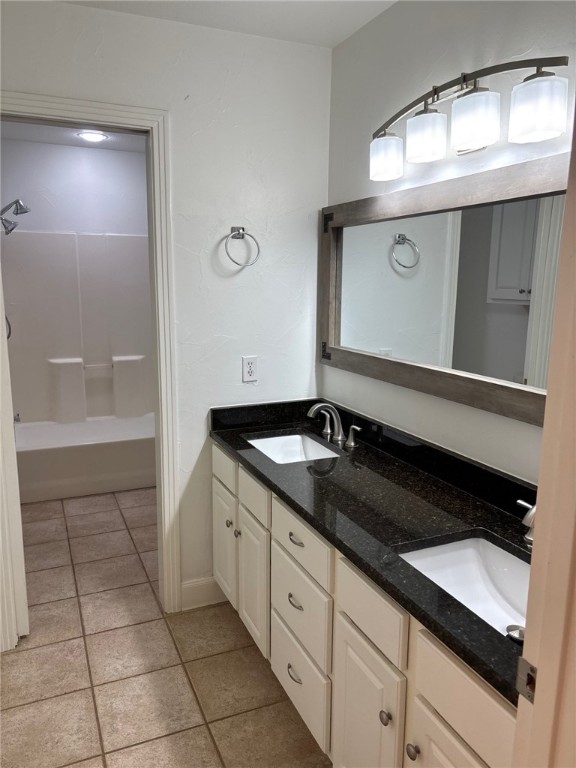 1132 Fifth Street Comfort, TX 78013 - Photo 10 of 20 a bathroom with a granite countertop sink a toilet and a mirror