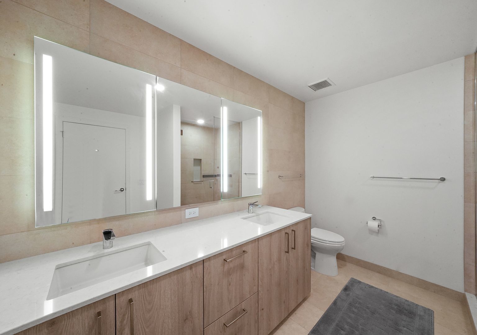 211 North Harbor Drive, Unit 2203 Chicago, IL 60601 - Photo 19 of 56 a bathroom with a sink a toilet and a large mirror