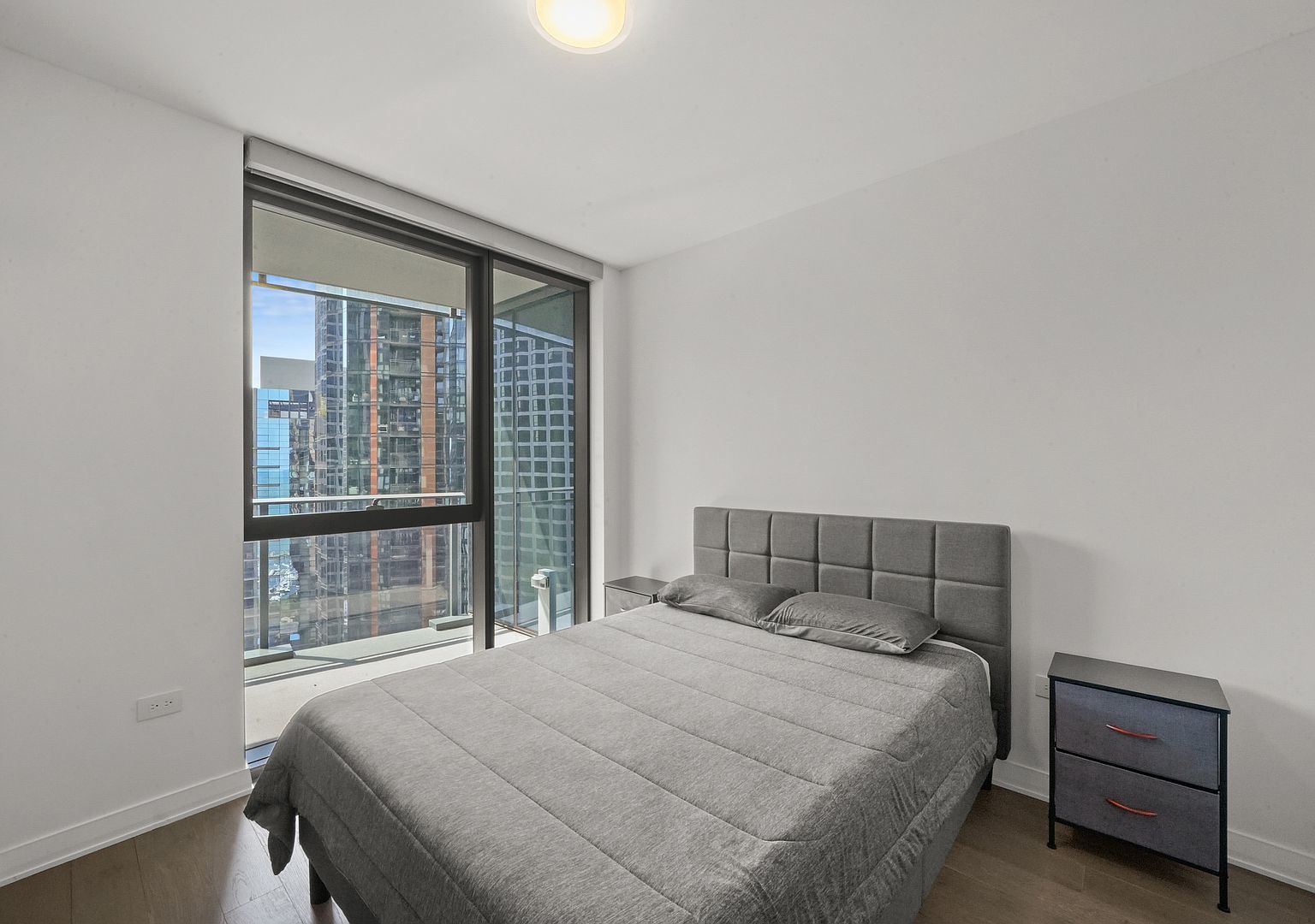 211 North Harbor Drive, Unit 2203 Chicago, IL 60601 - Photo 22 of 56 a bedroom with a bed and a window