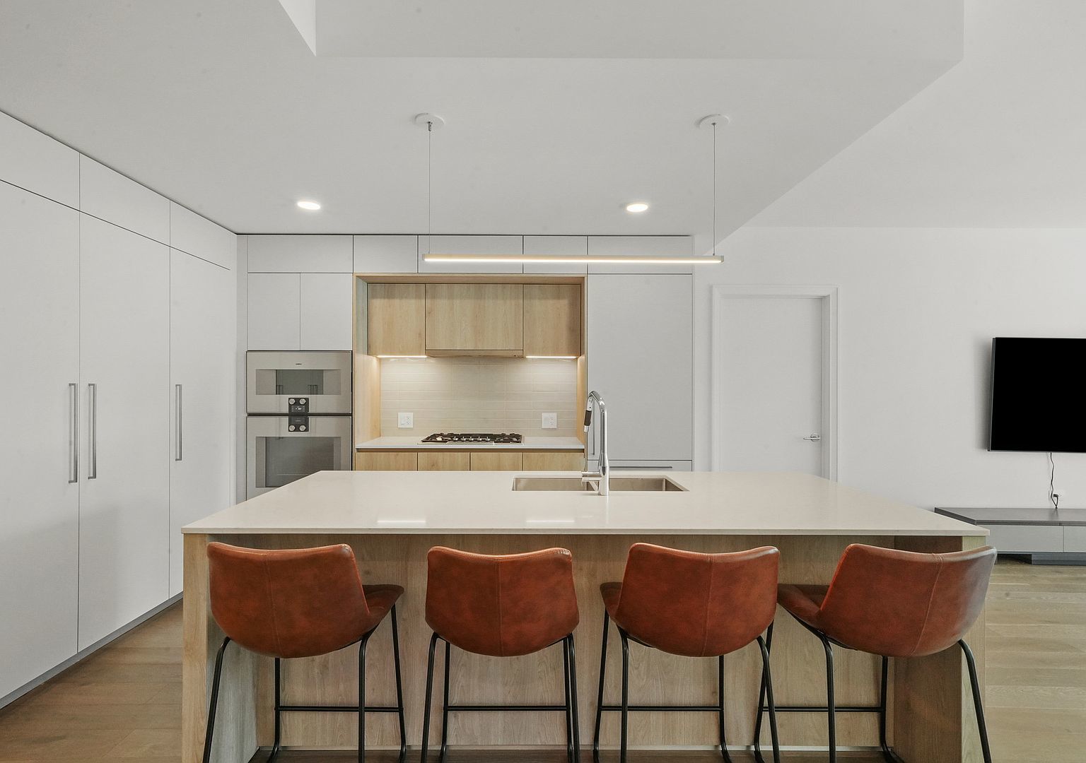211 North Harbor Drive, Unit 2203 Chicago, IL 60601 - Photo 4 of 56 a kitchen with granite countertop a table chairs stove and cabinets