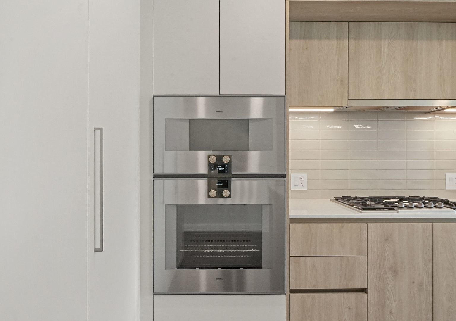 211 North Harbor Drive, Unit 2203 Chicago, IL 60601 - Photo 5 of 56 a kitchen with white cabinets and white appliances