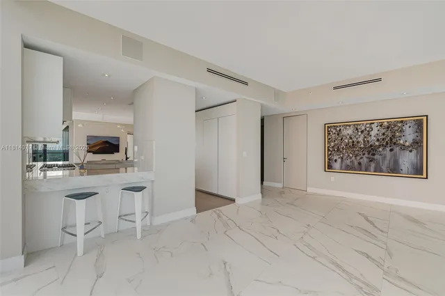 a kitchen with stainless steel appliances a refrigerator and a stove top oven