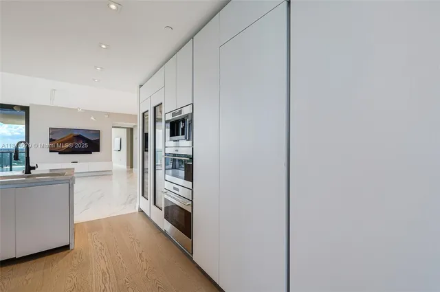 a kitchen with stainless steel appliances a refrigerator and a stove top oven
