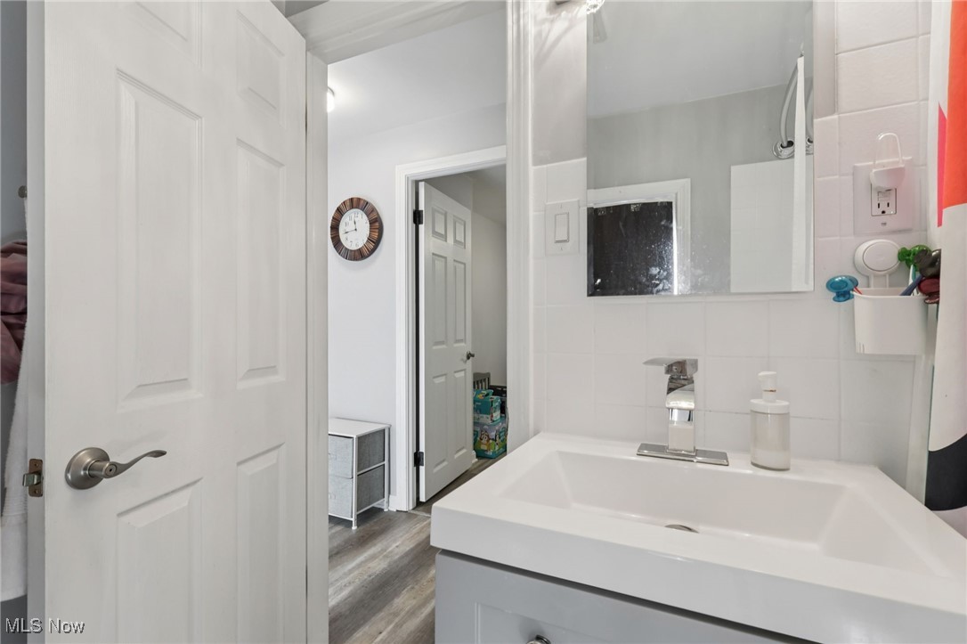1503 Oakmount Road South Euclid, OH 44121 - Photo 24 of 50 Bathroom with vanity, tasteful backsplash, and dark wood finished floors