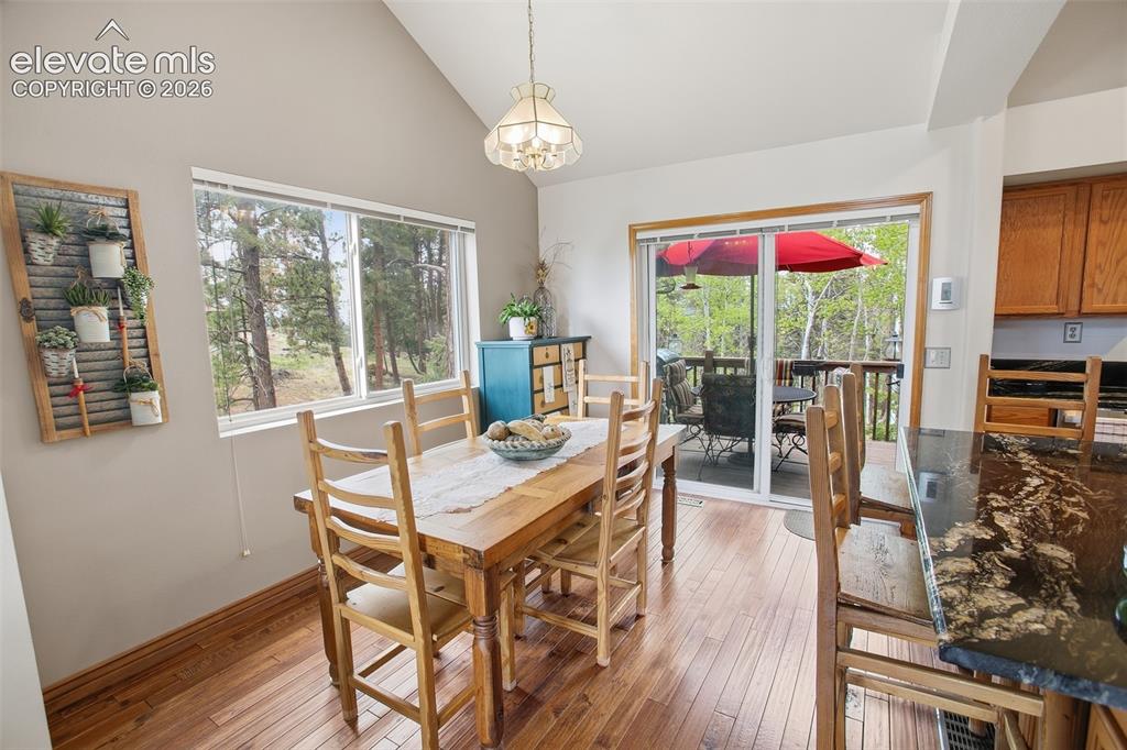 877 North Mountain Estates Road Florissant, CO 80816 - Photo 4 of 23 a view of a dining room with furniture wooden floor and chandelier