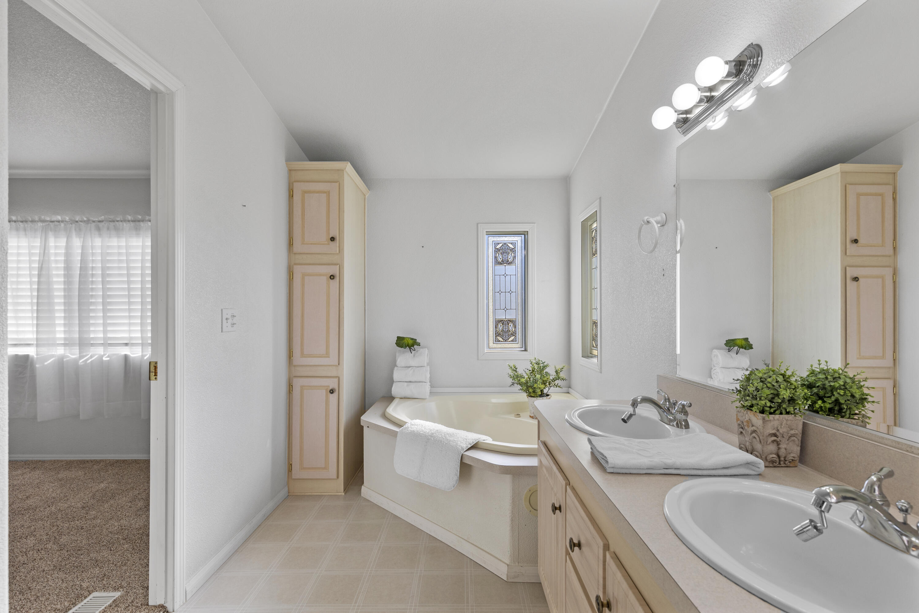 14556 East Tehachapi Boulevard Tehachapi, CA 93561 - Photo 16 of 23 a bathroom with a granite countertop sink a large mirror and a bathtub