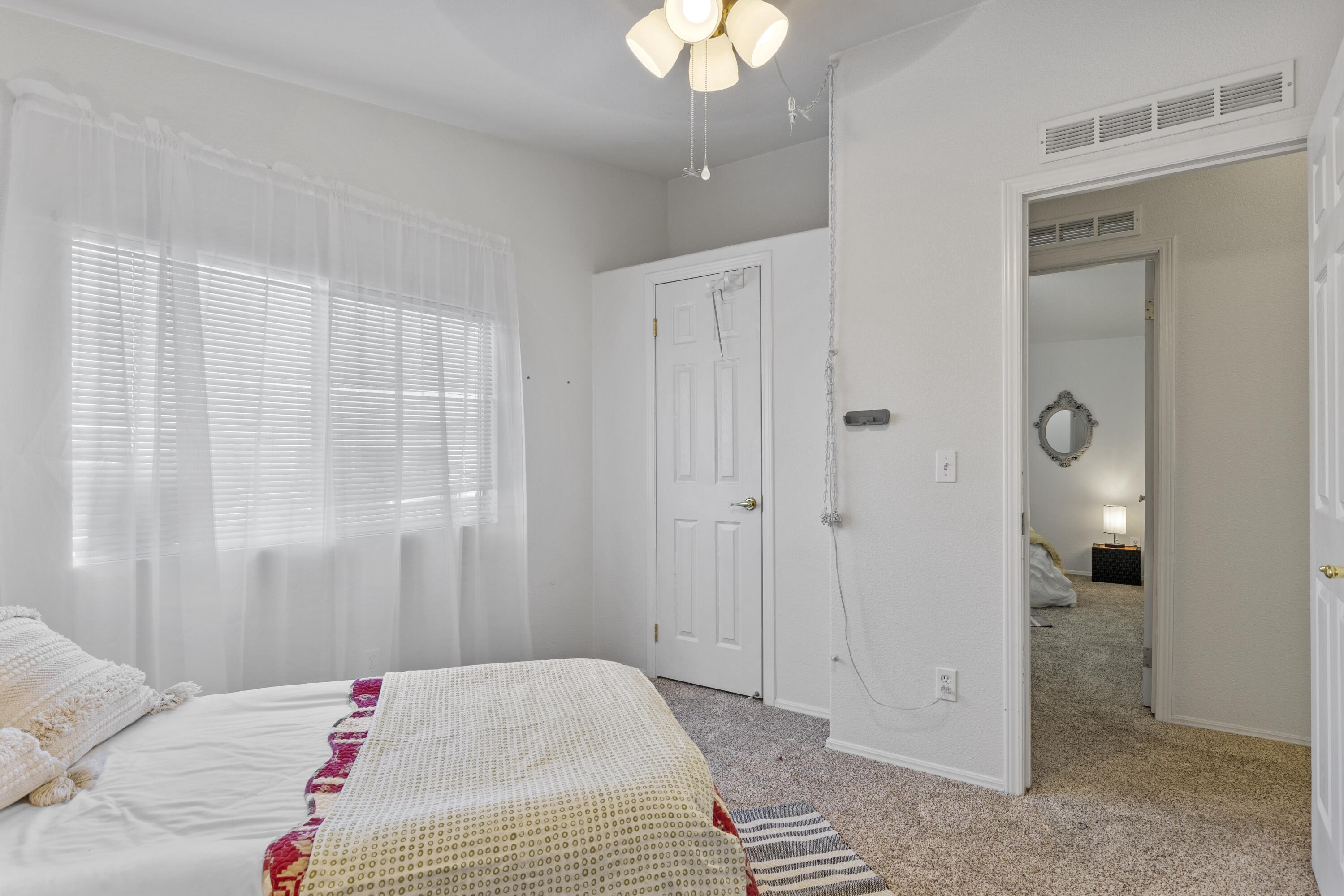 14556 East Tehachapi Boulevard Tehachapi, CA 93561 - Photo 19 of 23 a bedroom with a bed and a chandelier