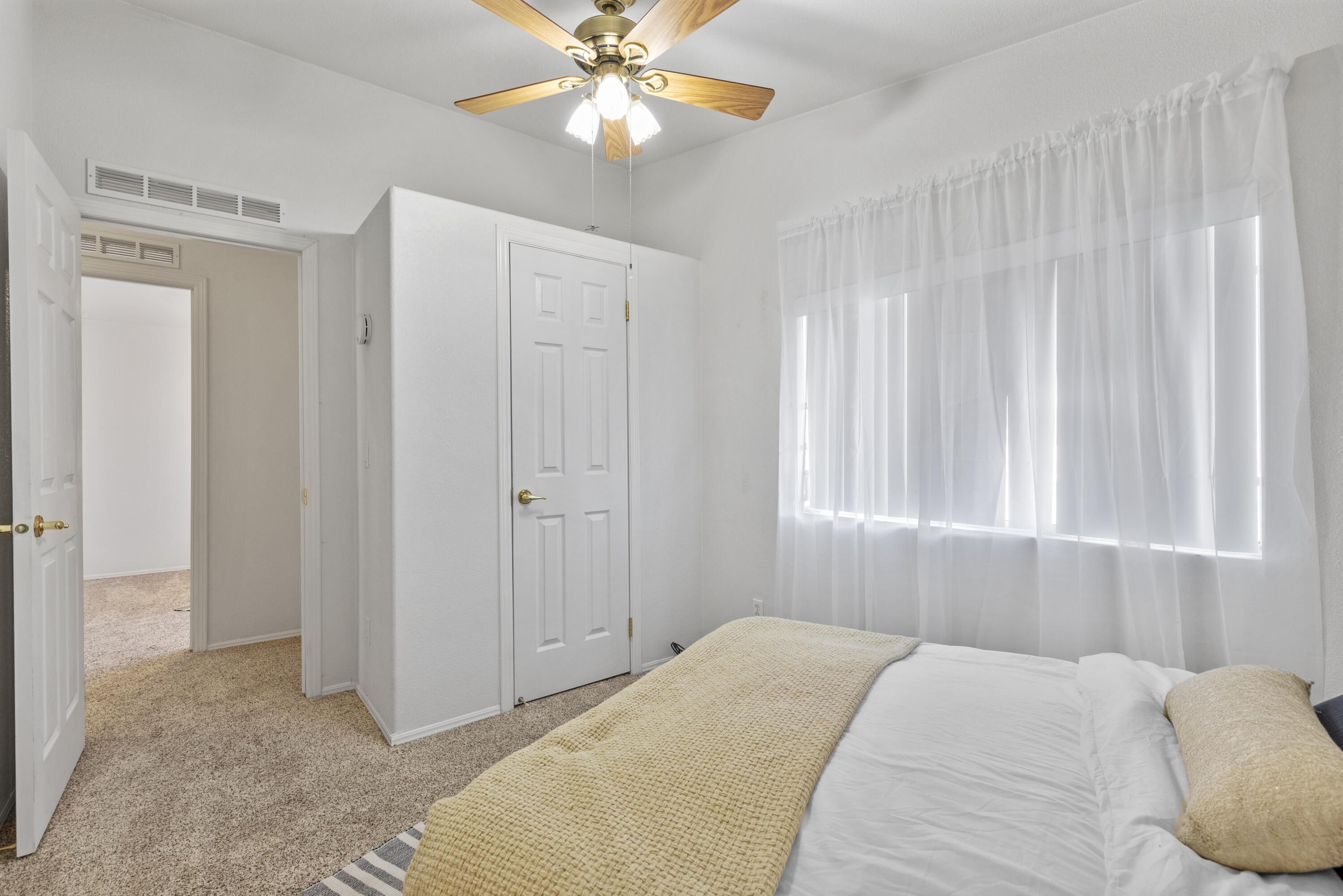 14556 East Tehachapi Boulevard Tehachapi, CA 93561 - Photo 21 of 23 a bedroom with a bed and a chandelier
