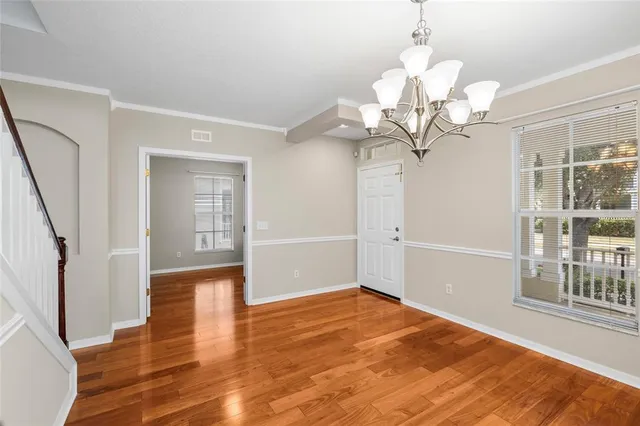 a bedroom with furniture and a wooden floor
