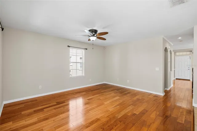 a kitchen with a sink a chandelier and wooden floor