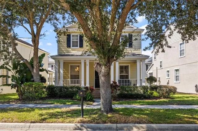 a front view of a house with a yard and outdoor seating