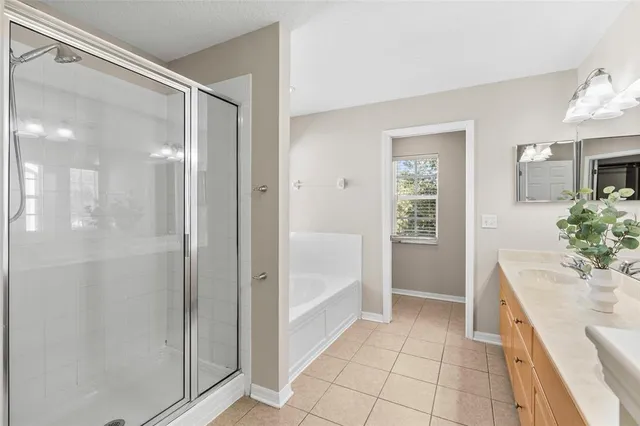 a view of a big room with wooden floor and windows