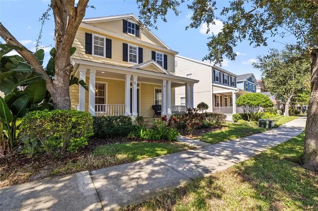 a living room with a balcony a bed top oven and a window