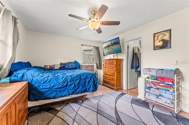 a bedroom with a bed and wooden floor