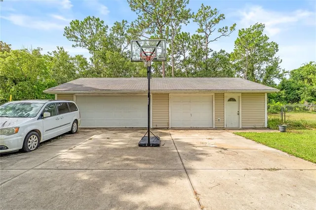 a view of a house with backyard space and parking