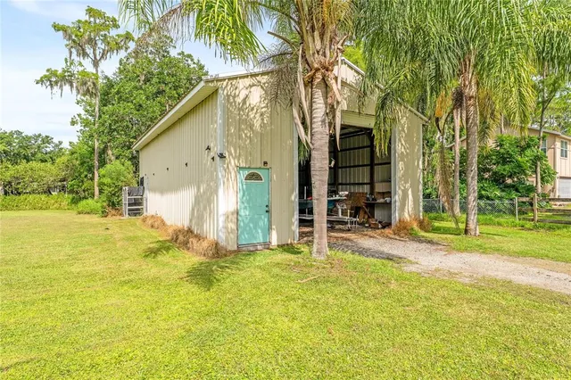 a view of a backyard with large trees
