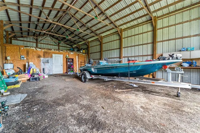 a backyard of a house with barbeque oven table and chairs