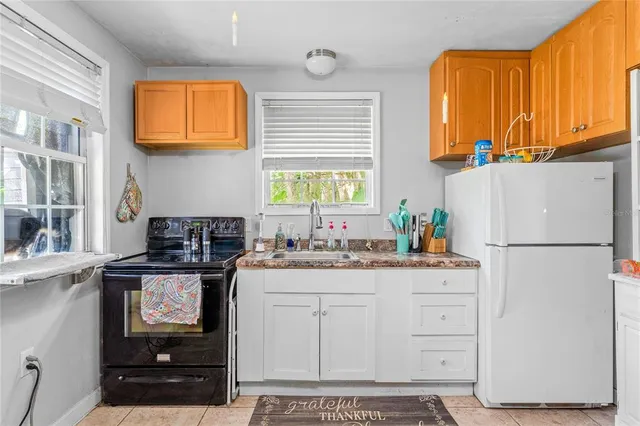 a kitchen with stainless steel appliances a stove a refrigerator and a sink