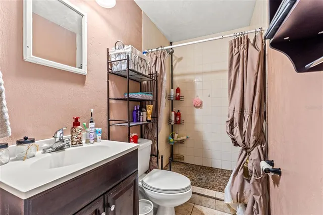 a bathroom with a sink toilet and shower