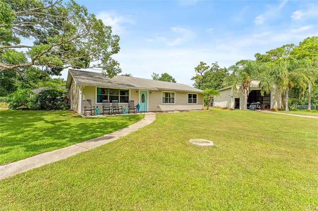 a view of house with yard