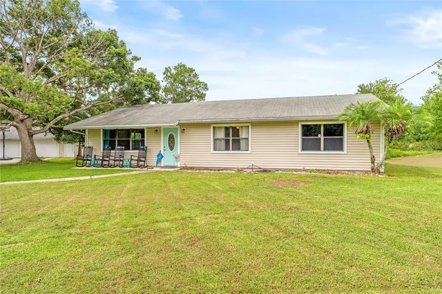 a front view of a house with yard and green space