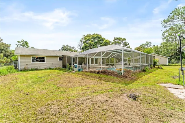 a view of a house with a backyard