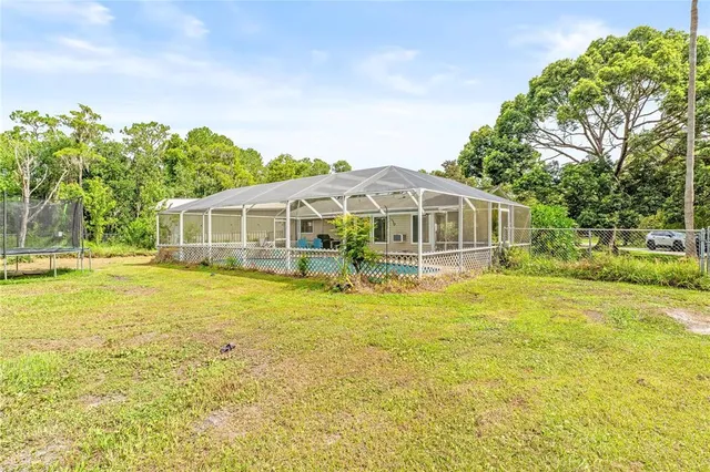 a house with swimming pool in front of it