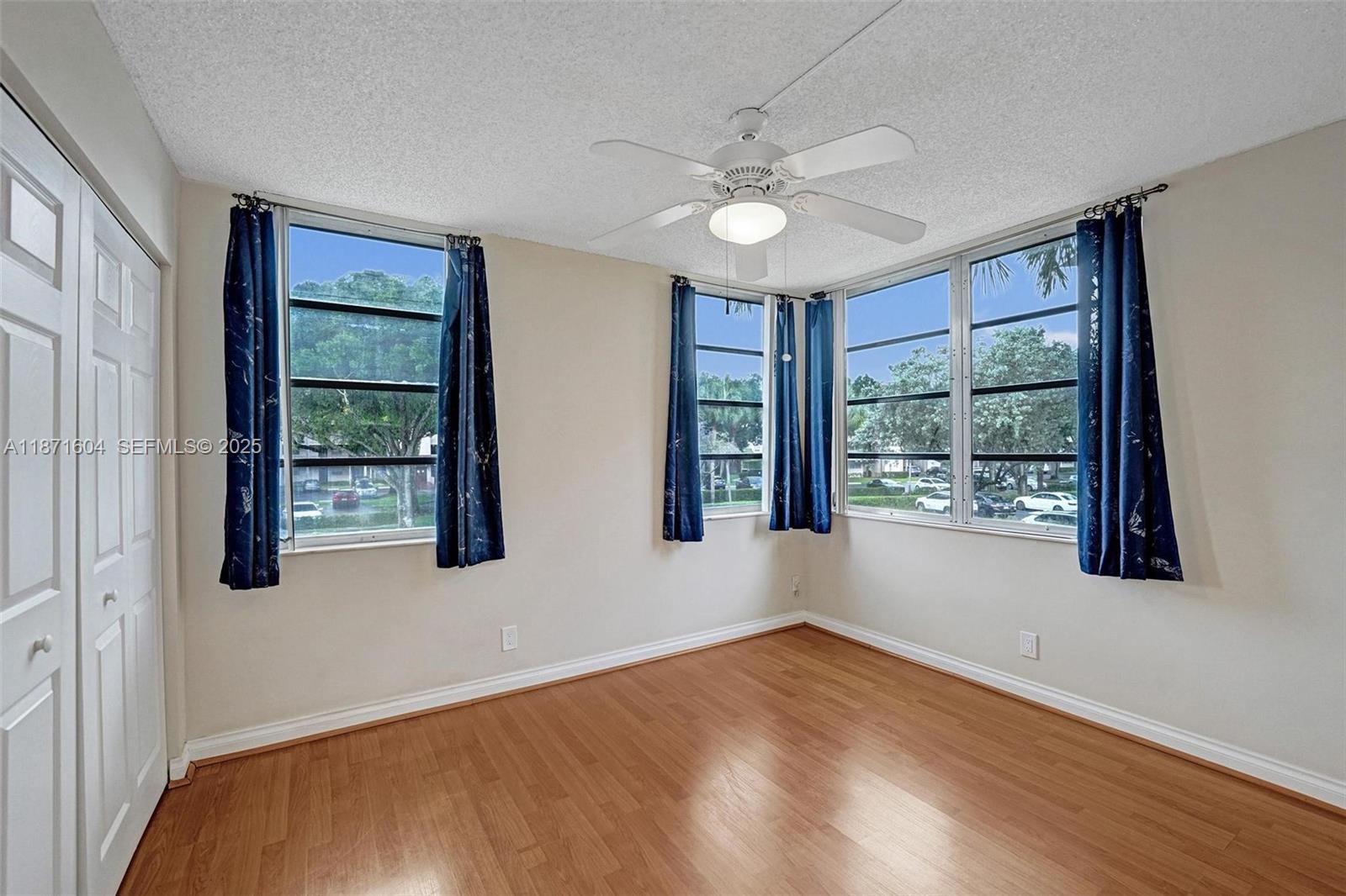 1900 Sabal Palm Drive, Unit 201 Davie, FL 33324 - Photo 13 of 23 a view of an empty room with a window and wooden floor