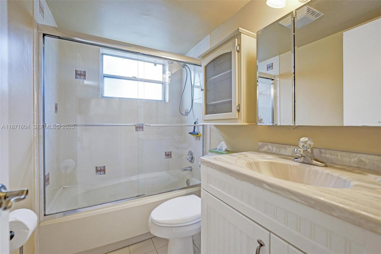 1900 Sabal Palm Drive, Unit 201 Davie, FL 33324 - Photo 16 of 23 a bathroom with a sink toilet and shower