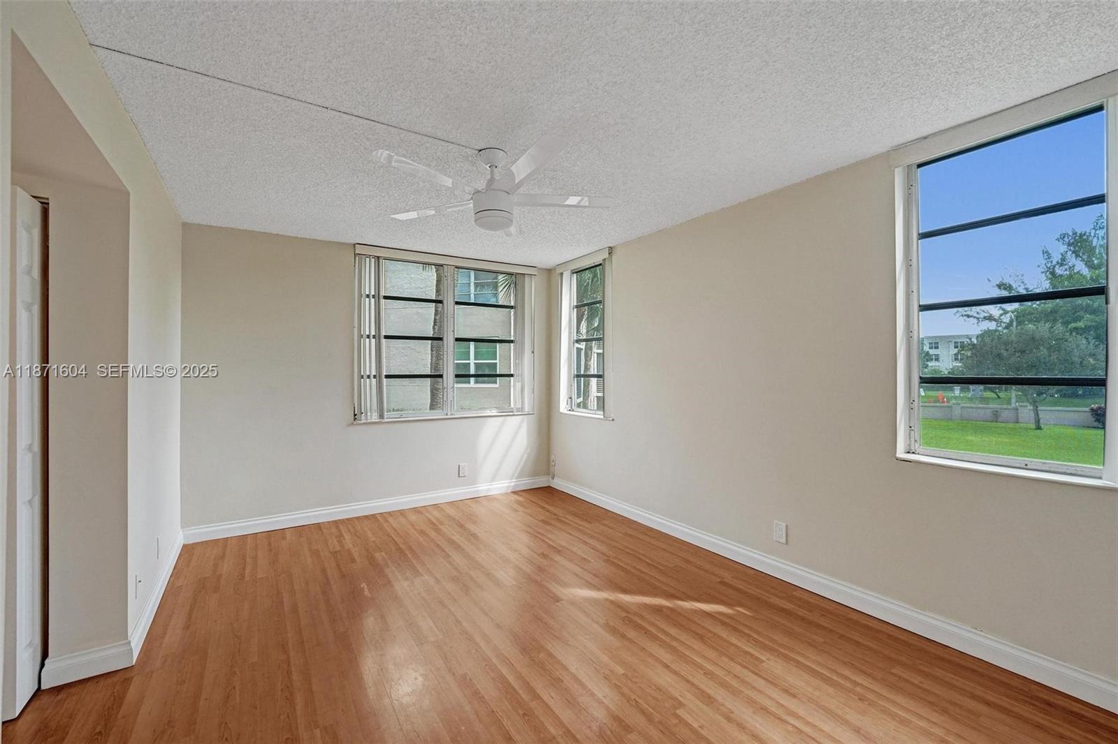 1900 Sabal Palm Drive, Unit 201 Davie, FL 33324 - Photo 17 of 23 a view of an empty room with wooden floor and a window