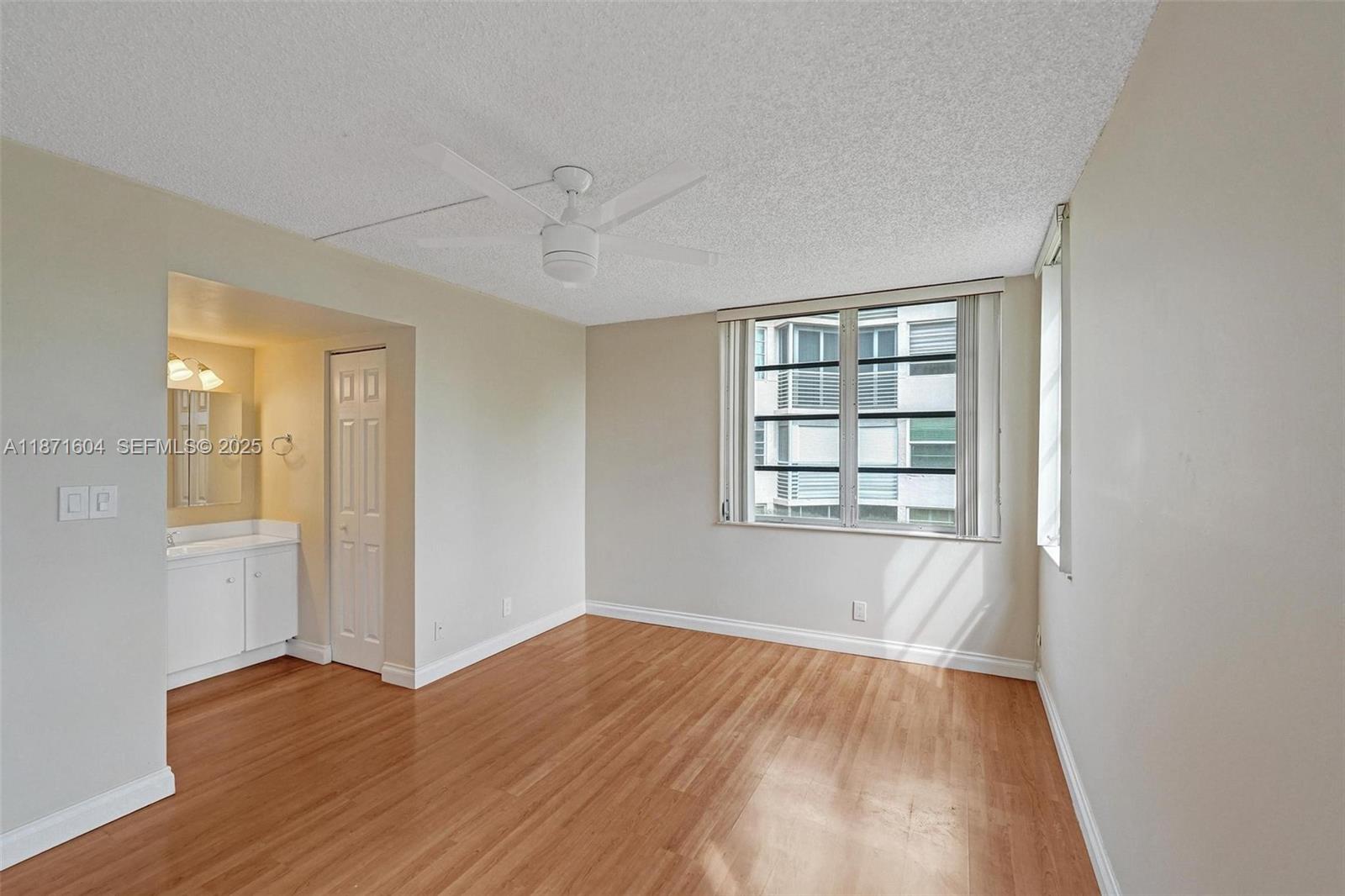1900 Sabal Palm Drive, Unit 201 Davie, FL 33324 - Photo 18 of 23 an empty room with wooden floor and windows