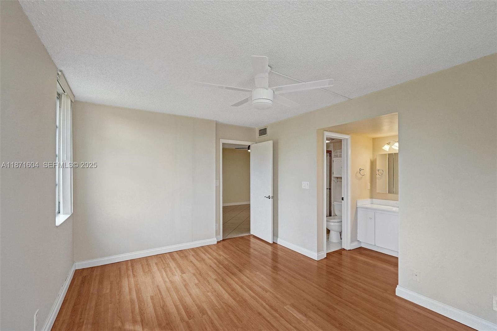 1900 Sabal Palm Drive, Unit 201 Davie, FL 33324 - Photo 19 of 23 an empty room with wooden floor and windows